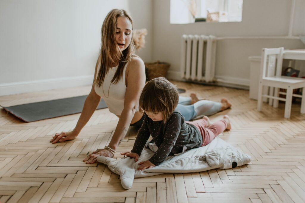 Au Pair doing Yoga with a girl